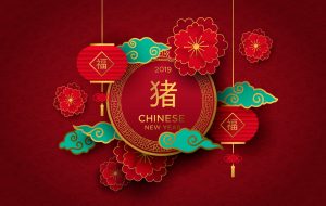 Chinese New Year 2019 traditional red greeting card illustration with traditional asian decoration and flowers in gold layered paper. Calligraphy symbol translation: pig, fortune.
