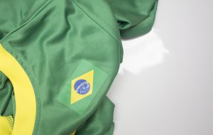 Green t-shirt with white collar and brazilian flag