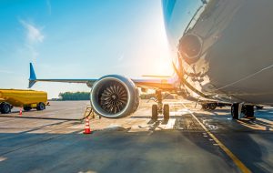 Sunset at the airport. Refueling of the airplane before flight, aircraft maintenance fuel at the airport
