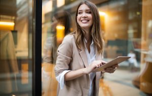Urban business woman using tablet computer and working