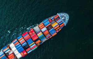 Cargo ship in import export and business logistic, Logistic and transportation of International Container Cargo ship in the open sea, Aerial shot from drone, Thailand.