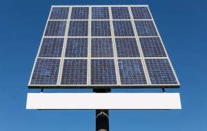 Blue sky and solar panel with hoarding and free copy space for text