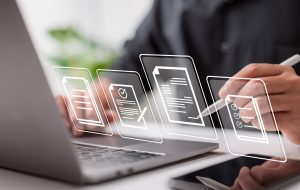 Paperless workplace idea, e-signing, electronic signature, document management. Businessman signs an electronic document on a digital document on a virtual notebook screen using a stylus pen.