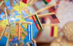 Close-up national flags stuck in the globe