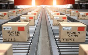 Made in China. Cardboard boxes with text made in China and chinese flag on the roller conveyor. 3d illustration