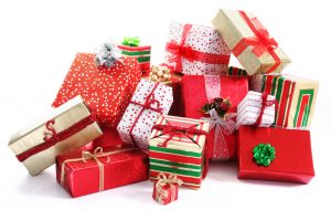 A pile of Christmas gifts in colorful wrapping with ribbons.