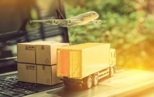 Air courier / freight forwarder or shipping service concept :  Boxes, a truck, white plane flies over a laptop, depicts customers order things from retailer sites via the internet and ship worldwide.