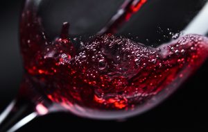 Red wine in wineglass on  black background